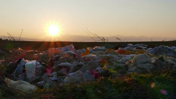 Sunset Over Scattered Garbage In Nature