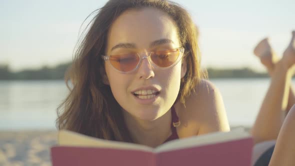 Close-up Face of Charming Brunette Young Woman Reading Out Loud. Portrait of Confident Beautiful