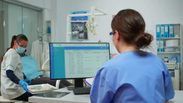 Orthodontist Assistant Taking Notes on Clipboard