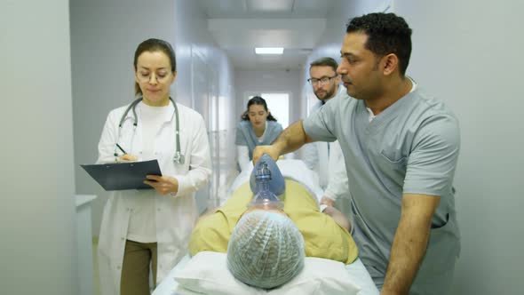 Doctors Pushing Emergency Patient on Gurney