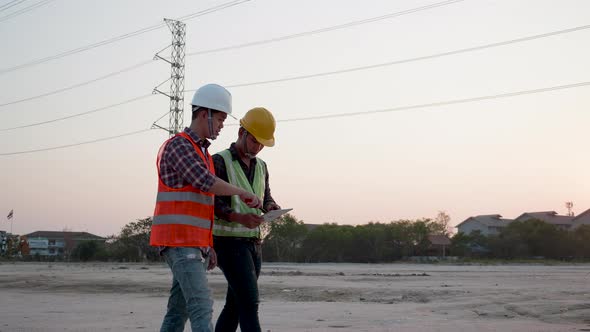 Two Electrical engineers discussing a construction site project