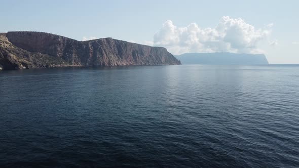 Aerial View From Above on Calm Azure Sea and Volcanic Rocky Shores