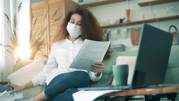 Female Worker Checks Documents While Staying Home During Quarantine, Working From Home Concept.