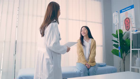 Asian woman patient visit and consult health problem with young doctor.