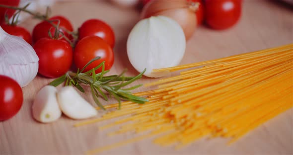 Fresh Food Ingredients On Wooden Table In Kitchen