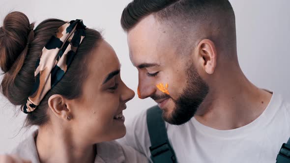 Happy Couple Painting Their First Apartment Together