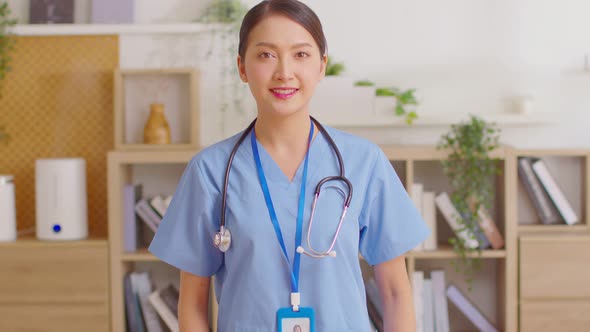 Asian female doctor with a stethoscope smile looking at camera.Nurses wear scrub smile with heartwar