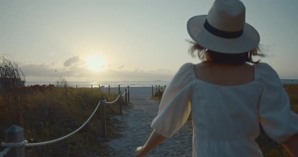 Young woman in a white dress in the morning