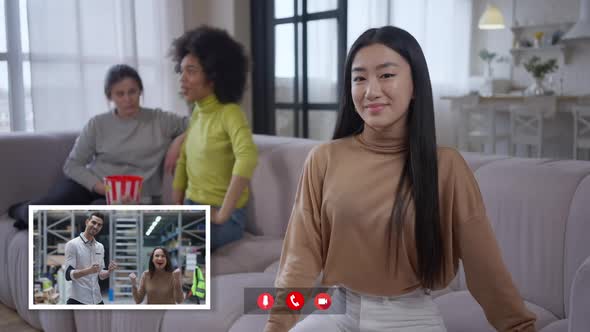 Slim Charming Asian Woman Looking at Camera As Middle Eastern Man and Caucasian Lady Rejoicing