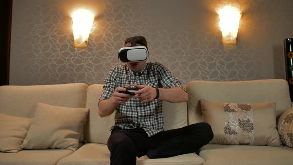 Young Male Wearing Virtual Reality Headset Playing Game