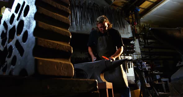 Blacksmith working on a iron rod