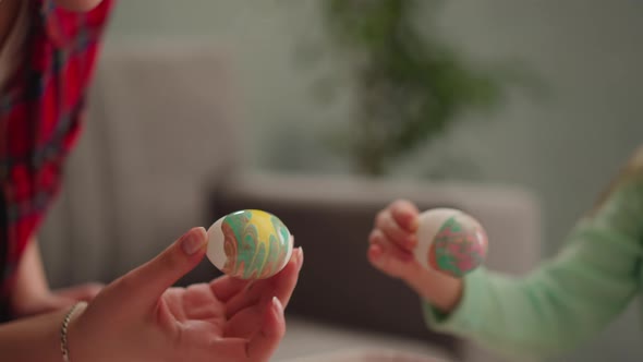 Mother and Little Daughter Hold Eggs with Marbling Decor
