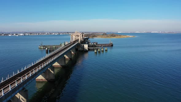 An aerial shot over Grassy Bay in Queens, NY. The camera dolly in along the length of the elevated t