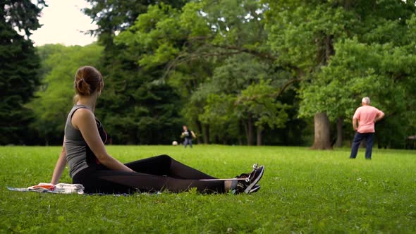 Girl Looks Like a Family Playing Football in the Meadow