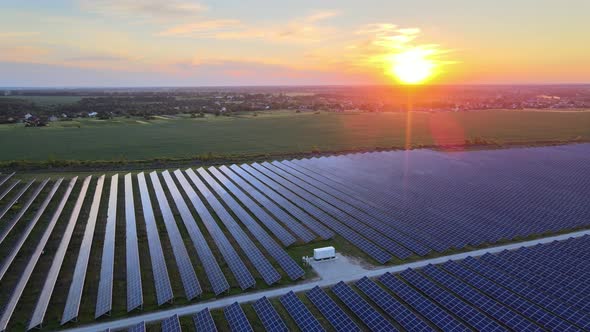 Aerial View of Large Solar Panels at a Solar Farm at Bright Summer Sunset. Solar Cell Power Plants