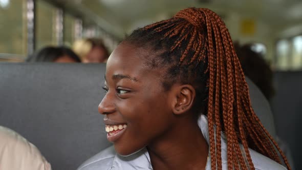 Pretty African American Girl Talking on School Bus