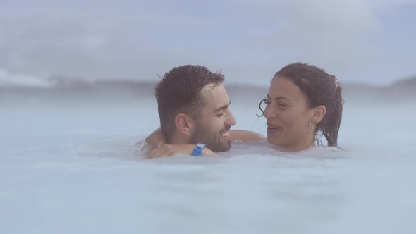 Loving Couple Embracing in Lagoon Geothermal Spa
