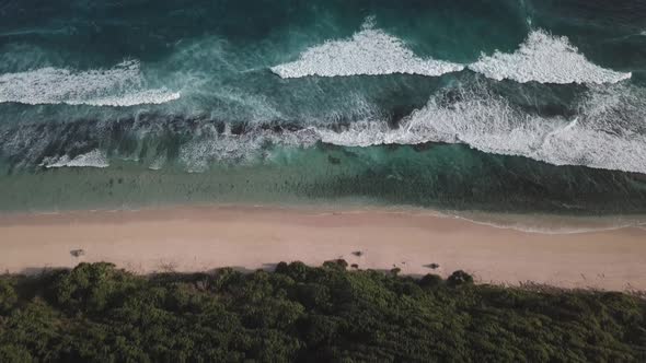 Aerial Top View of Ocean Waves Break on a Beach