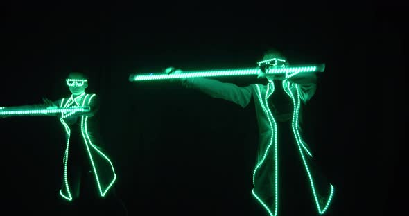 Two People Are Performing a Light Show on Stage of the Nightclub, 