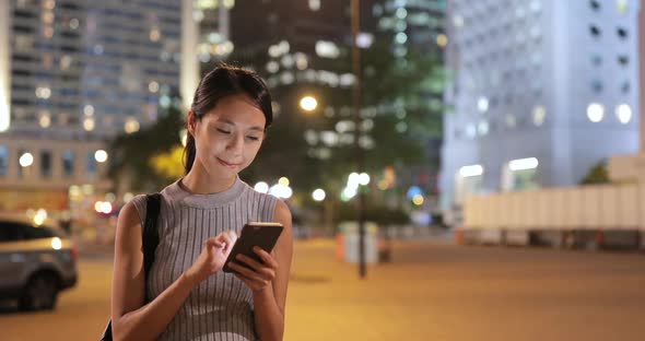 Woman using cellphone in the street at outdoor 