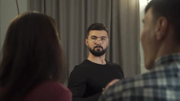 Bearded Young Male Psychologist Listening Carefully To His Clients