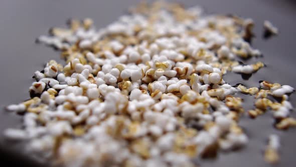 Preparation of amaranth seeds. Popped grains fall into the water in slow motion. Macro