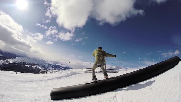 A young man snow boarding.