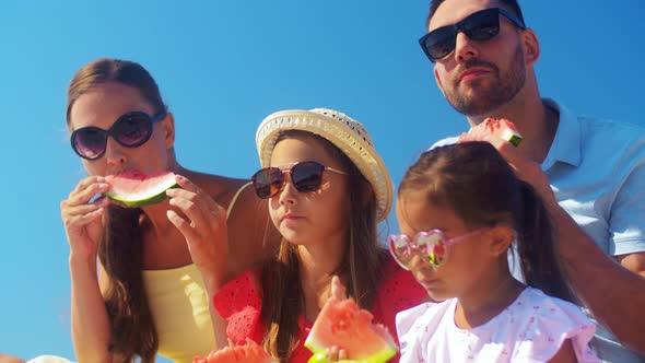 Happy Family Having Picnic and Eating Watermelon