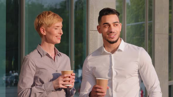 Multiracial Colleagues Caucasian Business Woman and Hispanic Bearded Man Enjoying Break Stand