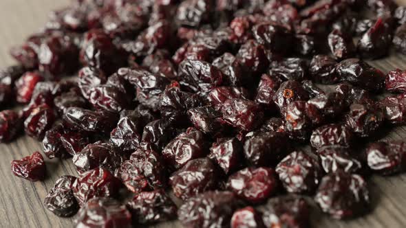 Panning over  red cranberries on table 4K 2160p 30fps UltraHD footage - Close-up of dried berries of