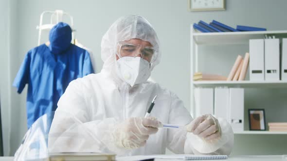 PCR Test in Laboratory Doctor Looking at COVID19 Swab Collection Kit Lab Worker Wearing PPE Medical