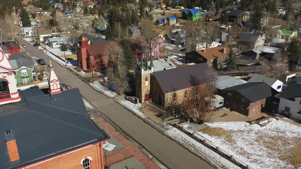 Urban neighbourhood with a small church on the street in a rural town in Colorado, USA. Aerial paral