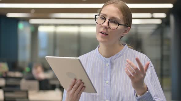 Portrait of Young Woman Having Loss on Tablet in Office