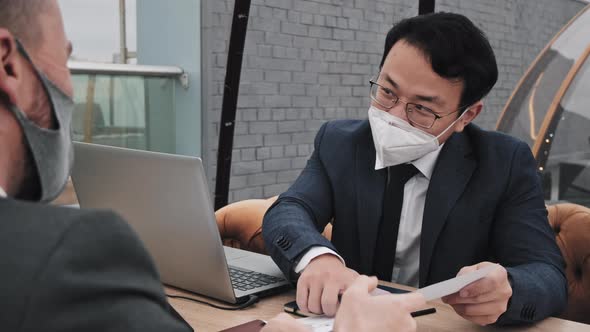 Asian Man in Mask on Business Meeting