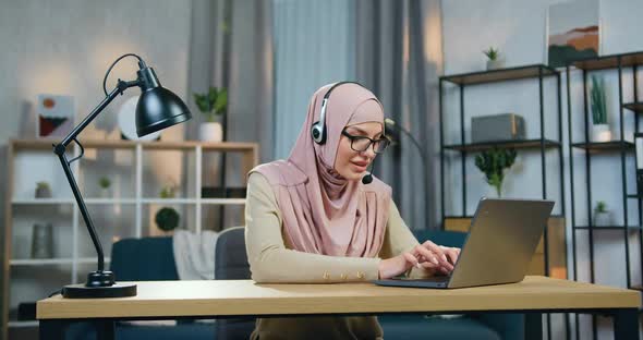 Arabic Woman in Hijab Sitting in front of Computer in Home Office