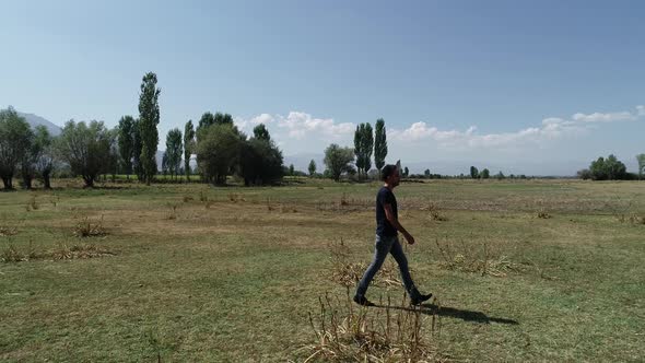 Young Man Walking Alone At Countryside