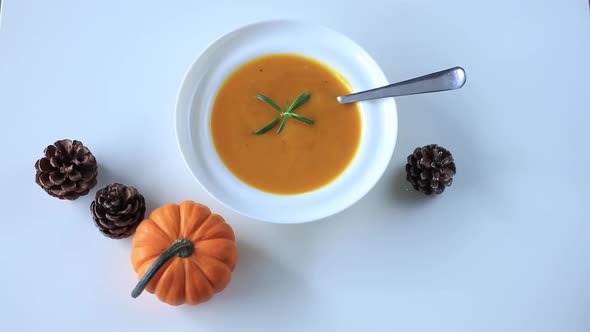 Pumpkin soup and pumpkin on a table. Top view