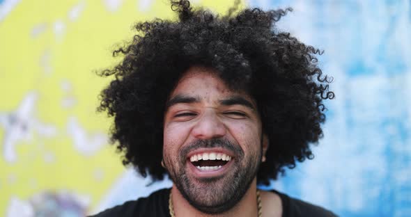 Happy young african man smiling on camera outdoor