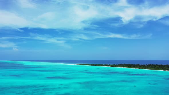 Natural fly over travel shot of a paradise sunny white sand beach and blue sea background in colourf