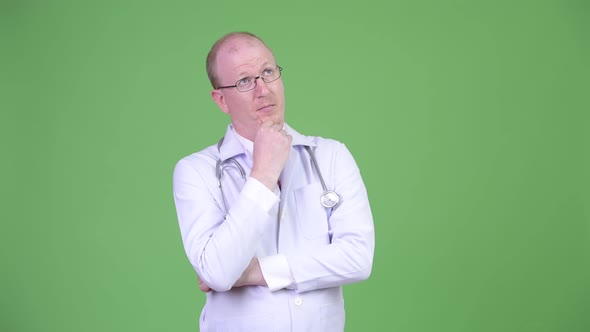 Serious Mature Bald Man Doctor Thinking