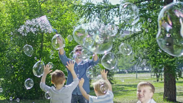 Performer Blowing Bubbles for Playful Kids in Park alt