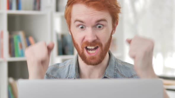 Casual Redhead Man Celebrating Success of Online Project