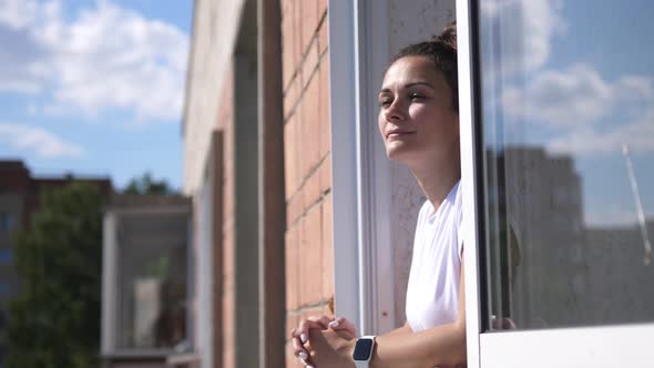 Cheerful Girl on the Balcony