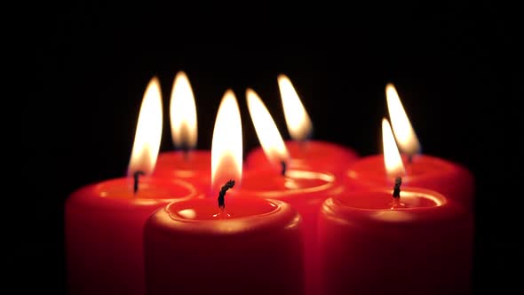 Red Christmas Candles Being Lit Up One by One on a Black Background in Time Lapse