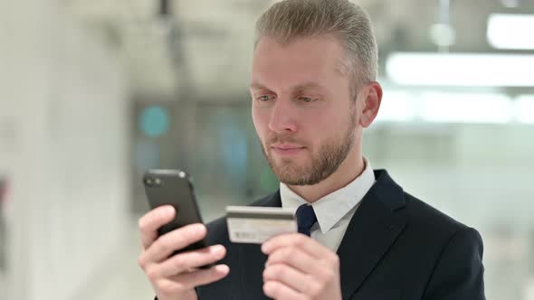 Portrait of Businessman Making Online Payment on Smartphone 