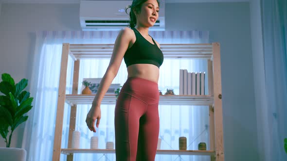 Asian young beautiful active sport woman doing cardio workout at home.
