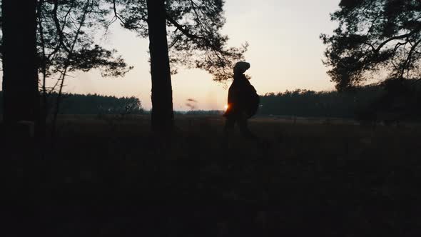 Girl Walks Through the Woods in the Evening