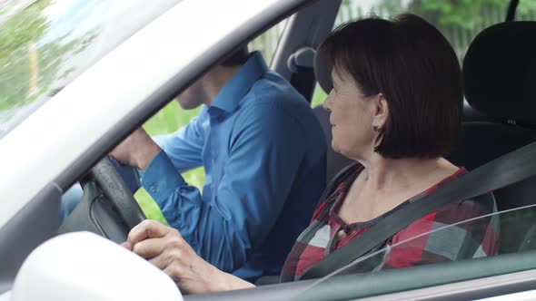 Aged Woman Learning To Drive a Car