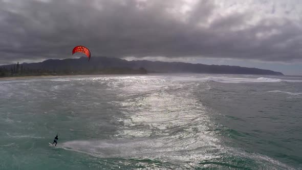 Aerial view of a man kitesurfing in Hawaii