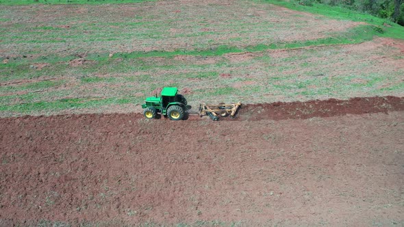 Tractor at rural landscape aerial view. Nature scenery